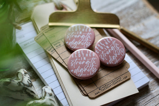 she is clothed in strength and dignity (Proverbs 31:25) flair button pin / magnet / flat back