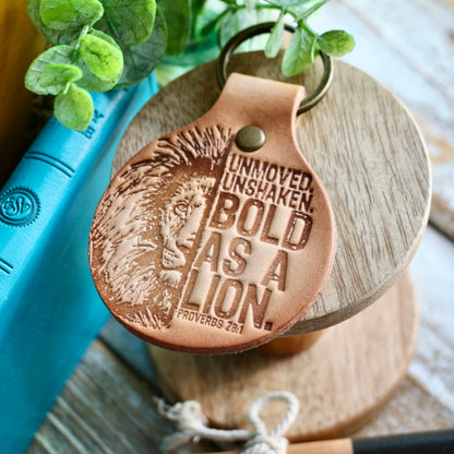 Unmoved. Unshaken. BOLD AS A LION. (Proverbs 28:1) leather keyring (camel/natural)