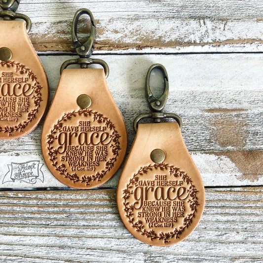 she gave herself grace because she knew He was strong in her weakness (2 Corinthians 12:9) leather key fob ring (camel/natural)
