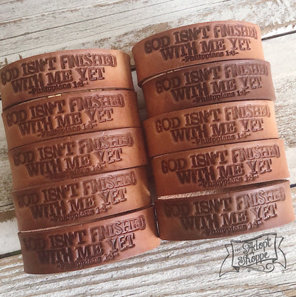 God isn’t finished with me yet (camel/natural) leather cuff